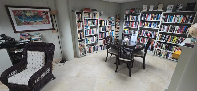 a living room with furniture a rug and a book shelf