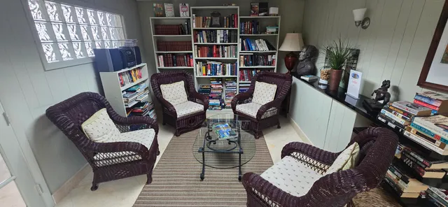 a living room with furniture and a book shelf