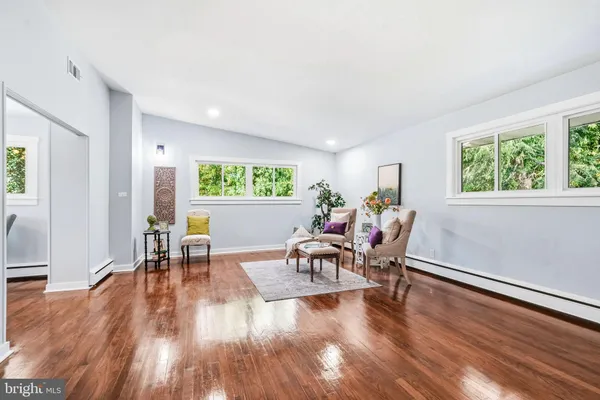 a dining room with furniture and wooden floor