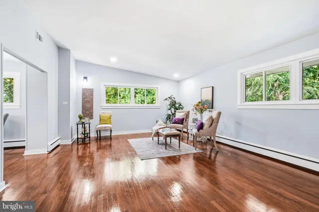 a dining room with furniture and wooden floor