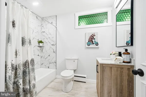 a bathroom with a toilet sink and tub
