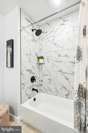 a bathroom with a bathtub and shower