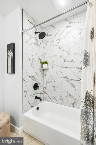 a bathroom with a bathtub and shower