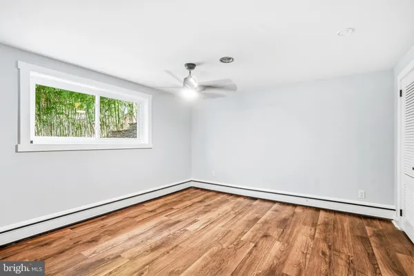 wooden floor in an empty room with a window