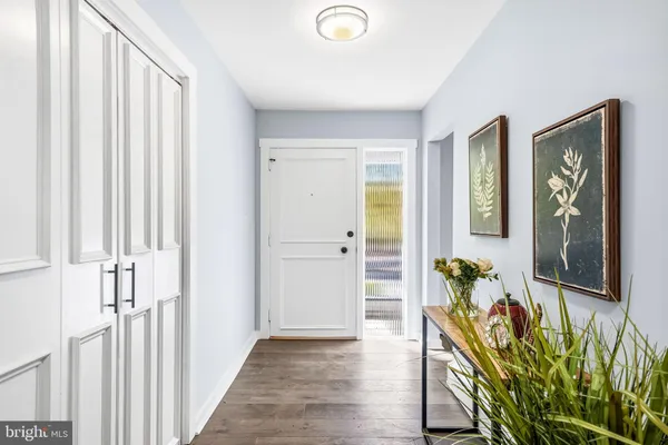 a view of an entryway with wooden floor