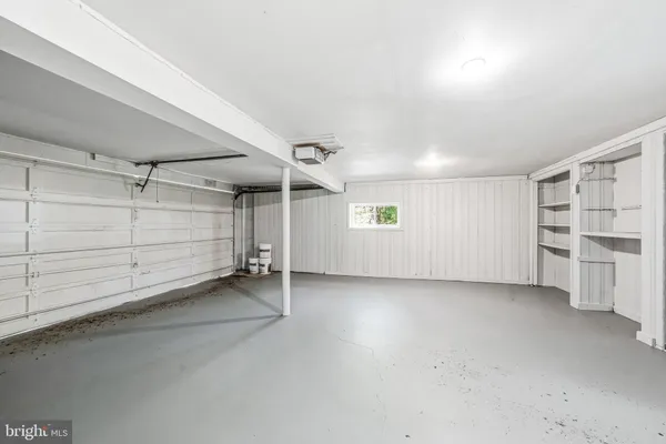 an empty room with a walk in closet and window