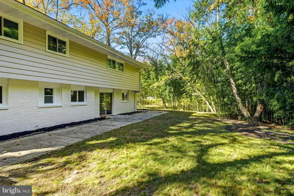 a view of a house with a yard and sitting area