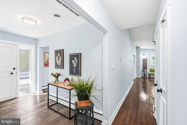 a hallway with wooden floor and furniture