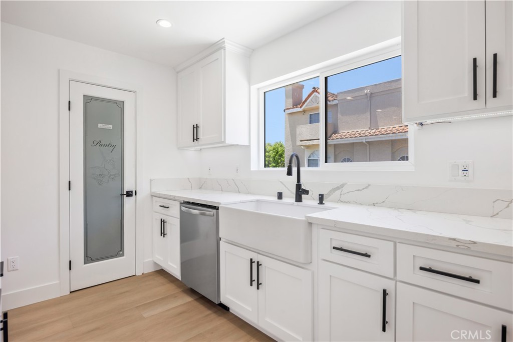 1715 West 149th Street, Unit B Gardena, CA 90247 - Photo 5 of 27 a kitchen with a sink cabinets and window