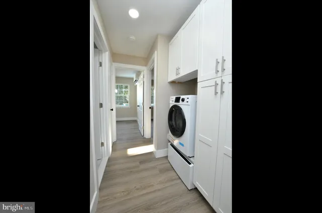 a view of kitchen with wooden floor and electronic appliances
