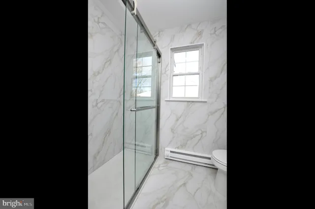 a spacious bathroom with a double vanity sink and a mirror