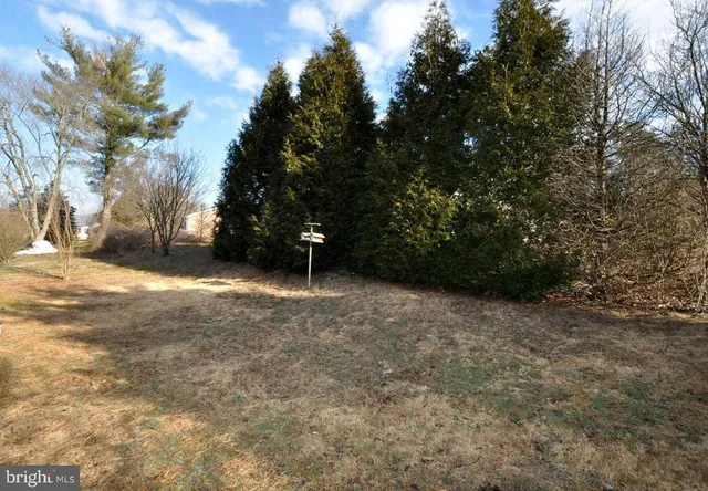 a view of a backyard with sitting area