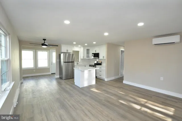 a view of a house with a yard covered in snow