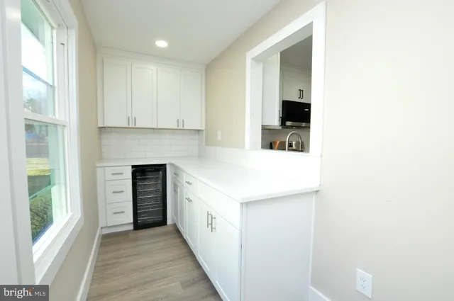 a kitchen with white cabinets stainless steel appliances and sink