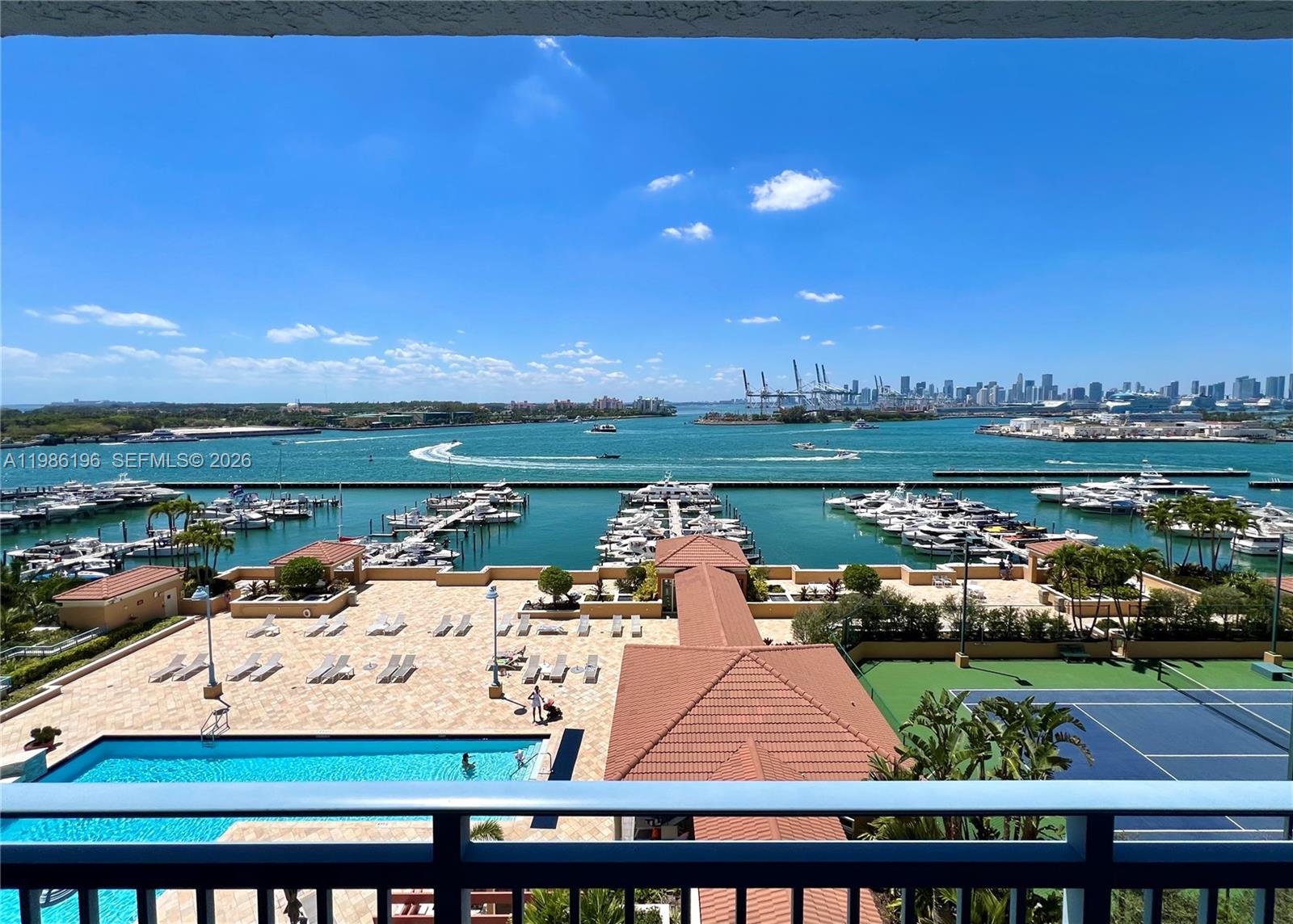 90 Alton Road, Unit 1106 Miami Beach, FL 33139 - Photo 13 of 21 a view of a lake with a table and chairs