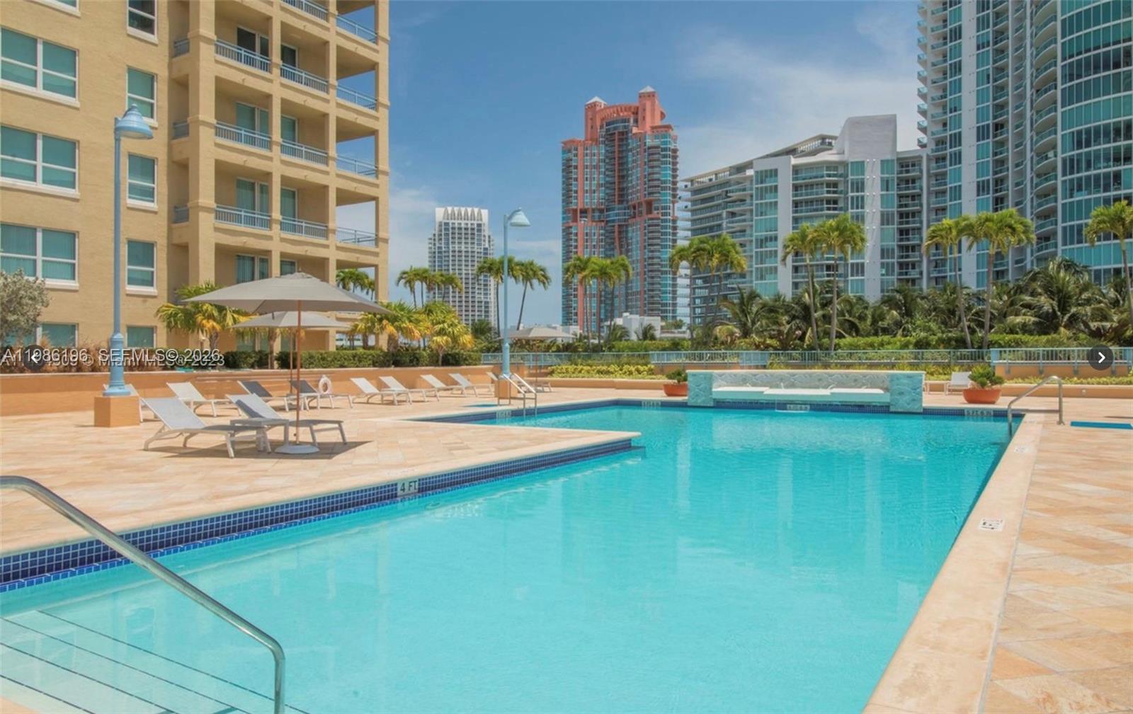 90 Alton Road, Unit 1106 Miami Beach, FL 33139 - Photo 17 of 21 a view of swimming pool with outdoor seating and city view