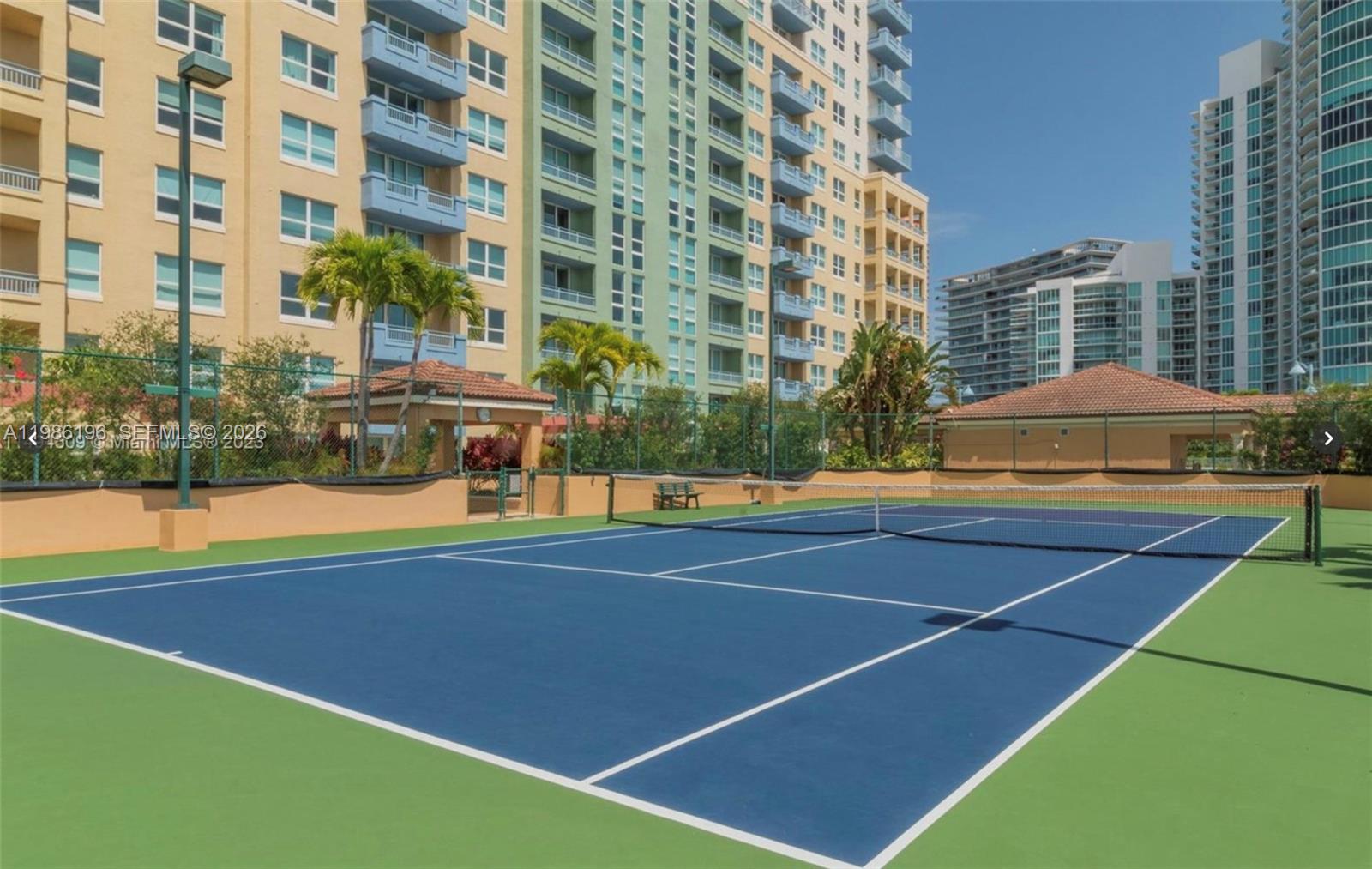 90 Alton Road, Unit 1106 Miami Beach, FL 33139 - Photo 21 of 21 a view of a tennis court with swimming pool in front of buildings