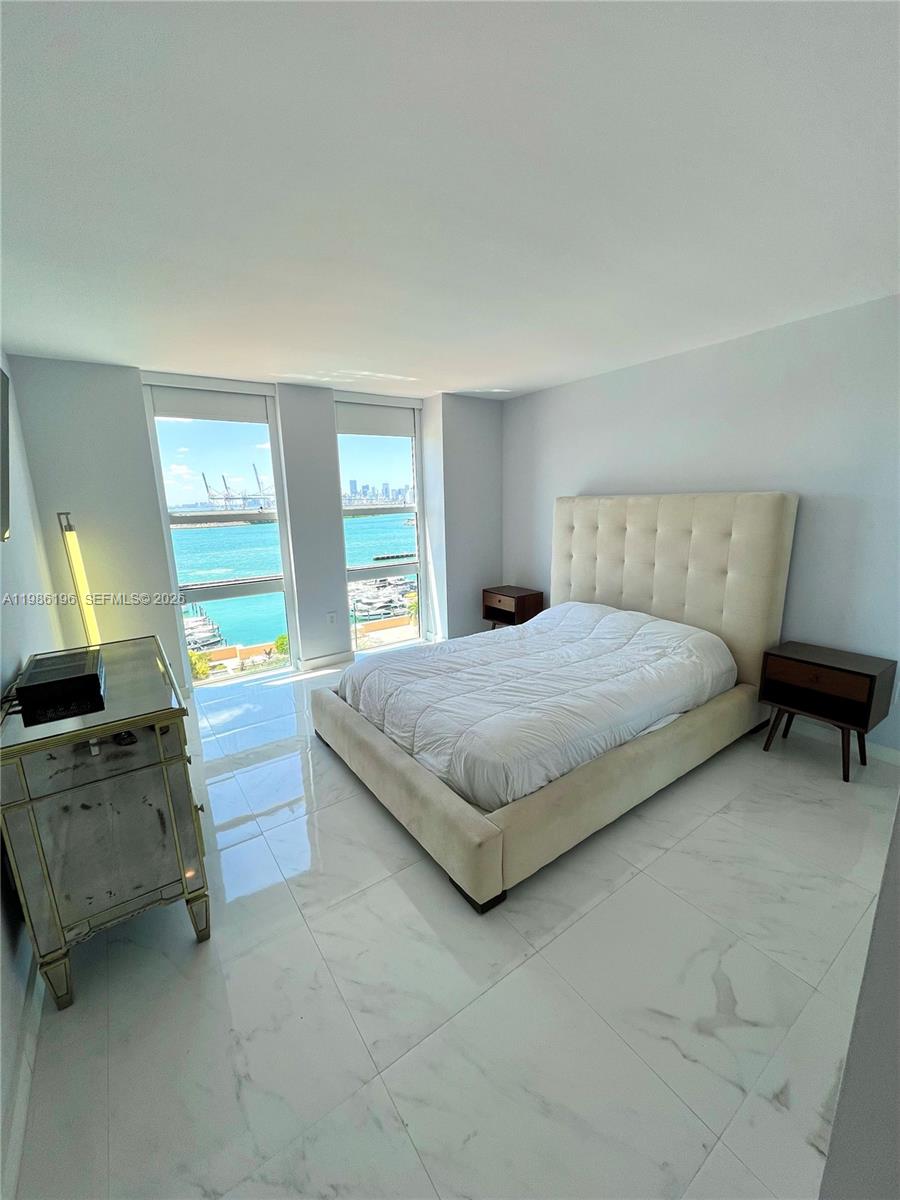 90 Alton Road, Unit 1106 Miami Beach, FL 33139 - Photo 8 of 21 a bedroom with a bed and a dressers