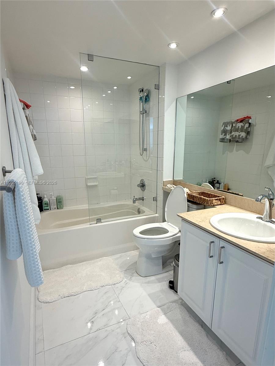 90 Alton Road, Unit 1106 Miami Beach, FL 33139 - Photo 9 of 21 a bathroom with a sink a toilet and shower