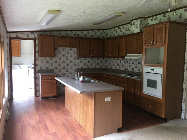 16 Garrett Road Edgefield, SC 29824 - Photo 3 of 13 a kitchen with a stove and a refrigerator