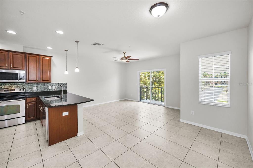 5032 Sand Castle Drive New Port Richey, FL 34652 - Photo 24 of 87 a kitchen with stainless steel appliances granite countertop a stove a sink and a refrigerator