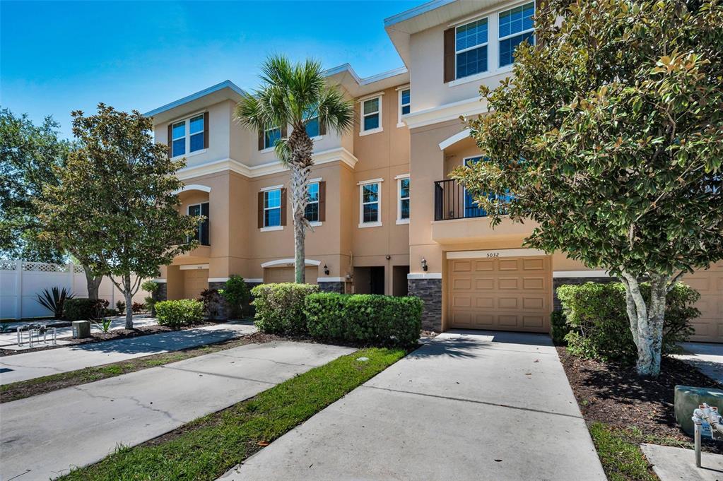 5032 Sand Castle Drive New Port Richey, FL 34652 - Photo 3 of 87 a front view of a house with a yard and a garage