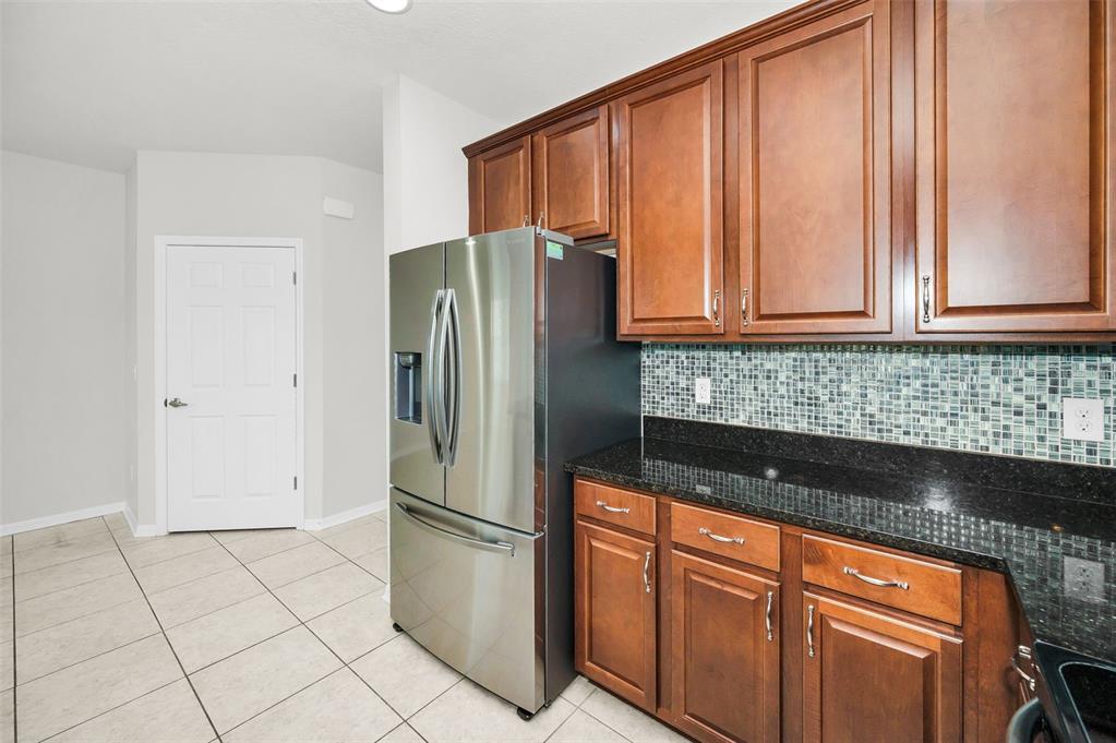 5032 Sand Castle Drive New Port Richey, FL 34652 - Photo 31 of 87 a kitchen with stainless steel appliances granite countertop a refrigerator sink and cabinets