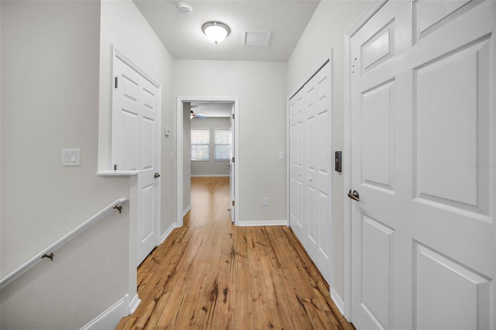 5032 Sand Castle Drive New Port Richey, FL 34652 - Photo 36 of 87 a view of a hallway with wooden floor and staircase