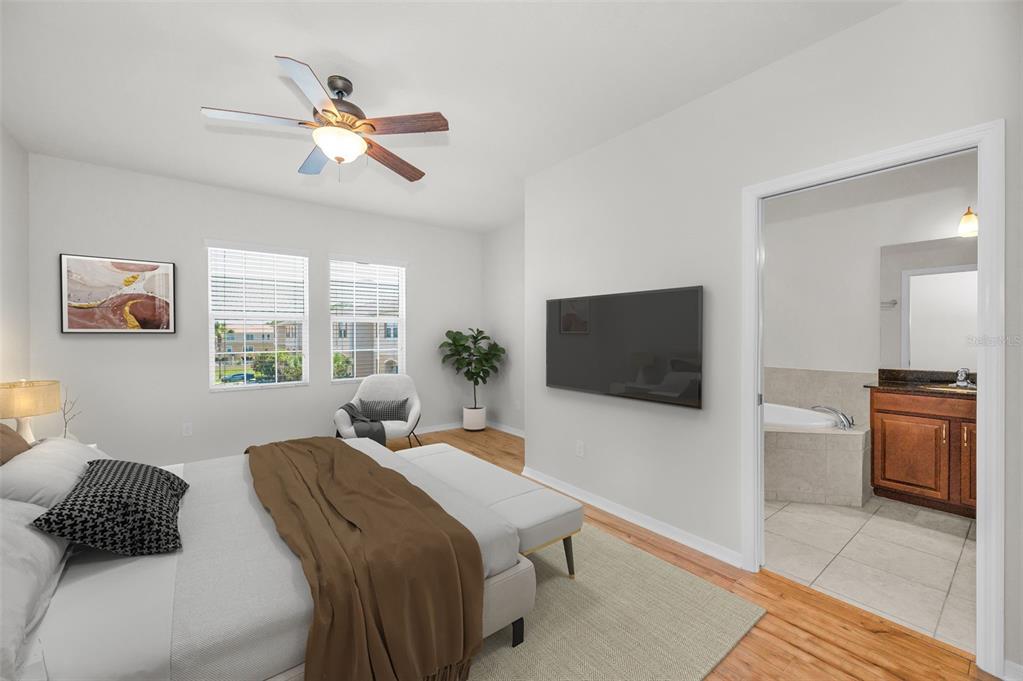 5032 Sand Castle Drive New Port Richey, FL 34652 - Photo 39 of 87 a bedroom with a bed and a flat screen tv