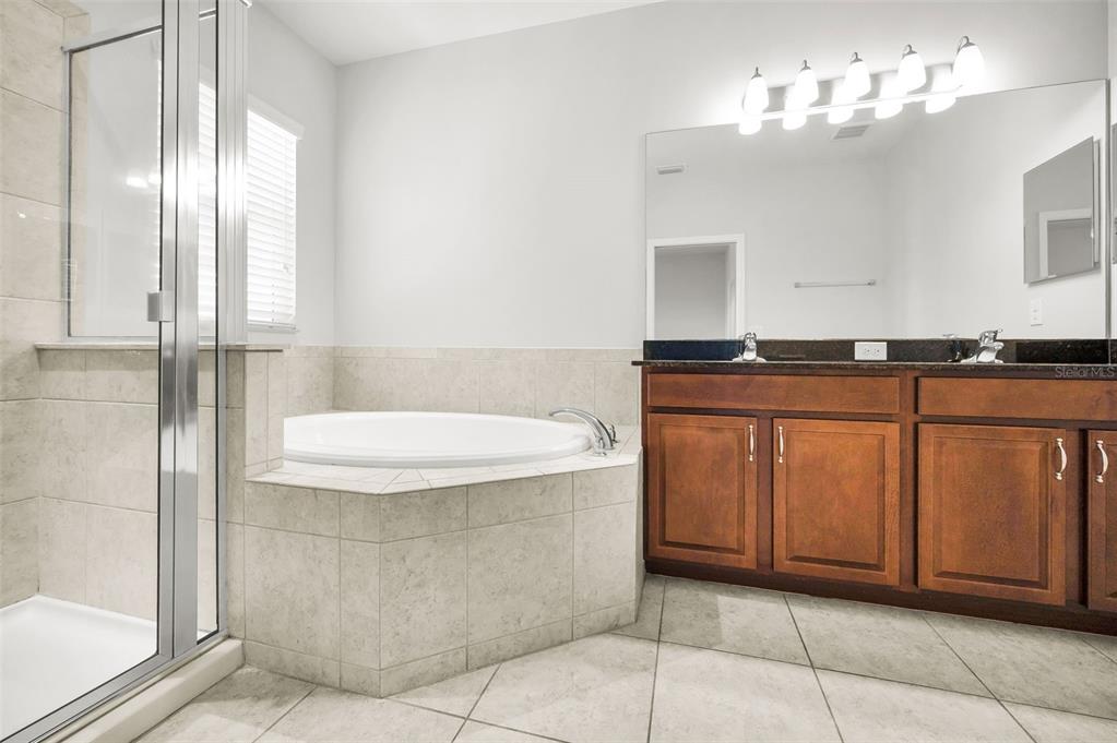 5032 Sand Castle Drive New Port Richey, FL 34652 - Photo 43 of 87 a bathroom with a granite countertop sink and a mirror