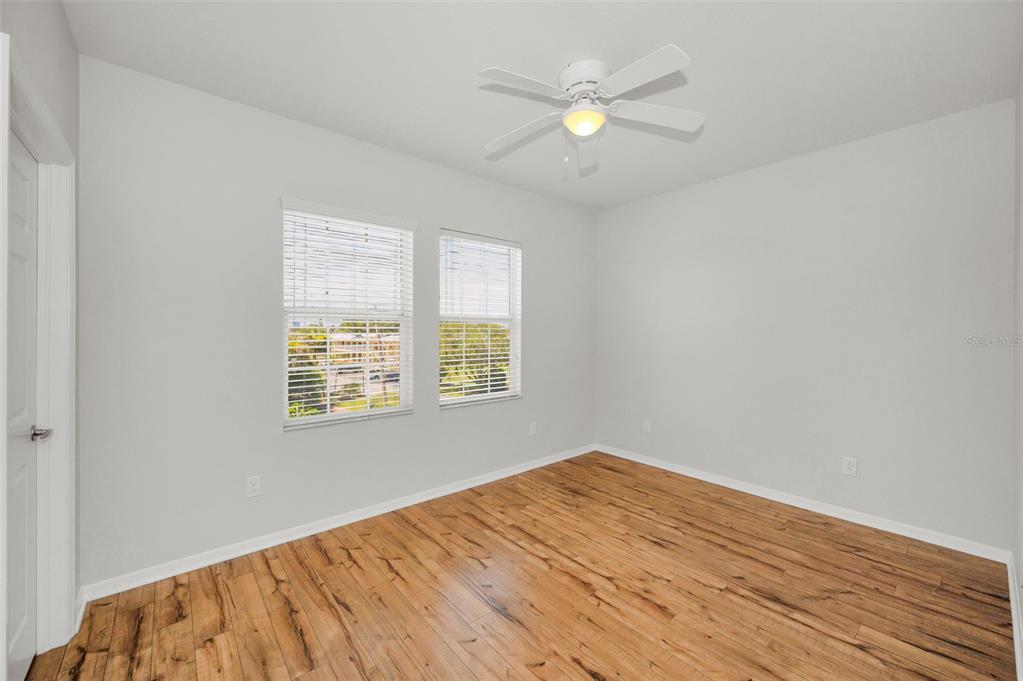 5032 Sand Castle Drive New Port Richey, FL 34652 - Photo 47 of 87 an empty room with wooden floor and windows