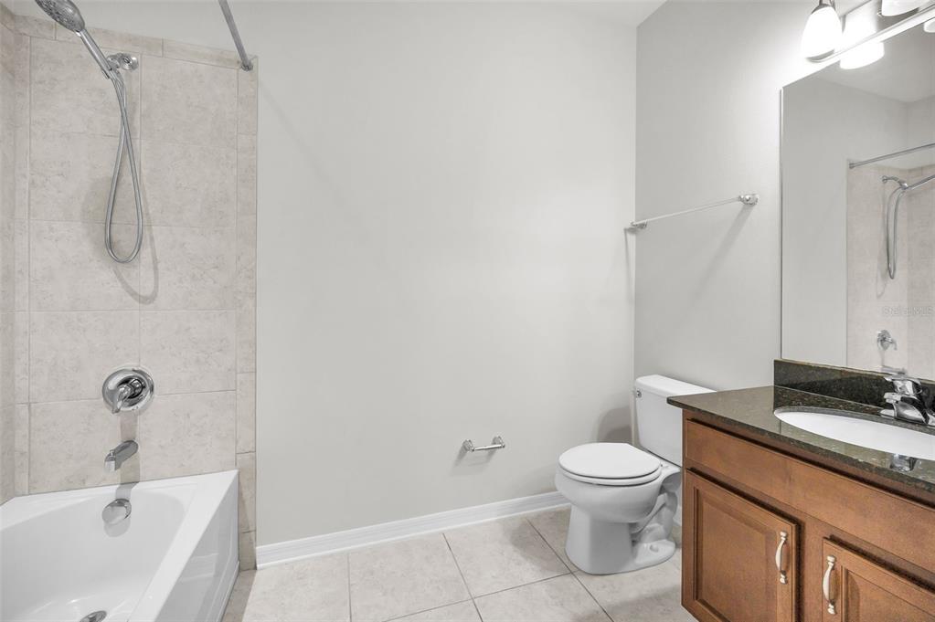 5032 Sand Castle Drive New Port Richey, FL 34652 - Photo 48 of 87 a bathroom with a granite countertop sink toilet and a mirror