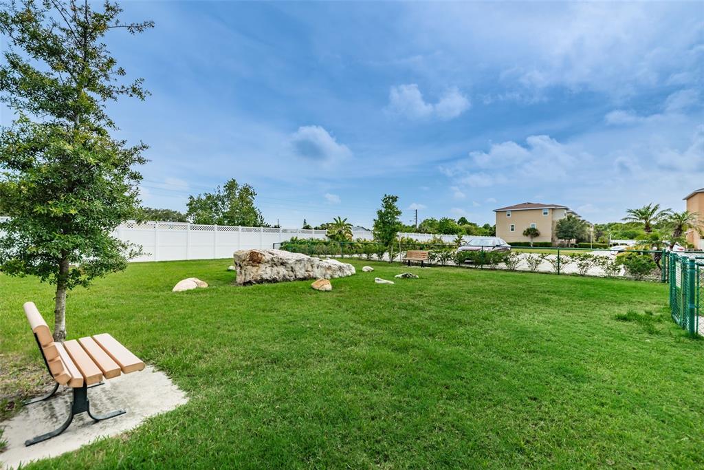 5032 Sand Castle Drive New Port Richey, FL 34652 - Photo 64 of 87 a view of a bench in the garden near a lake