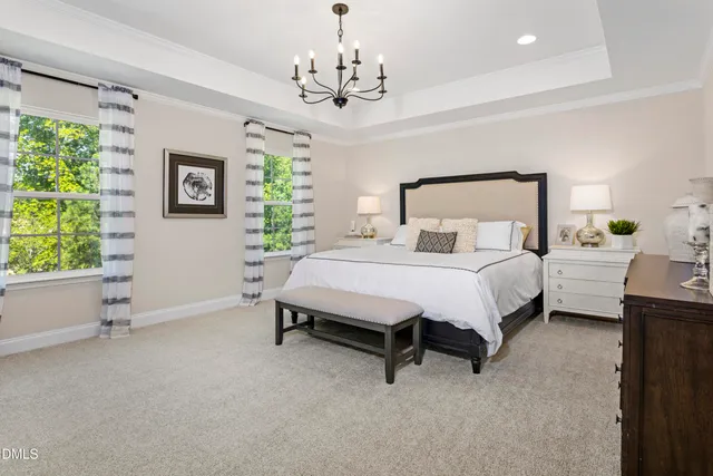 a spacious bedroom with a bed and a window