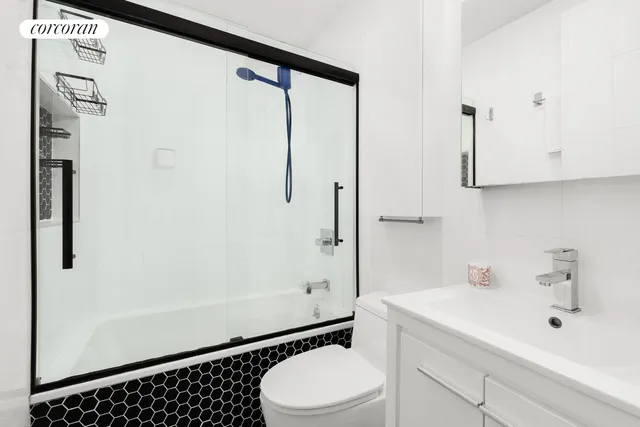 a bathroom with a sink a toilet and shower