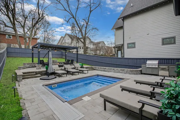 a view of a backyard with sitting area
