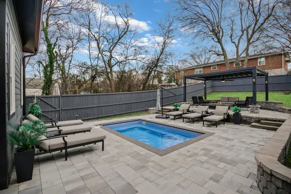 a view of a backyard with sitting area