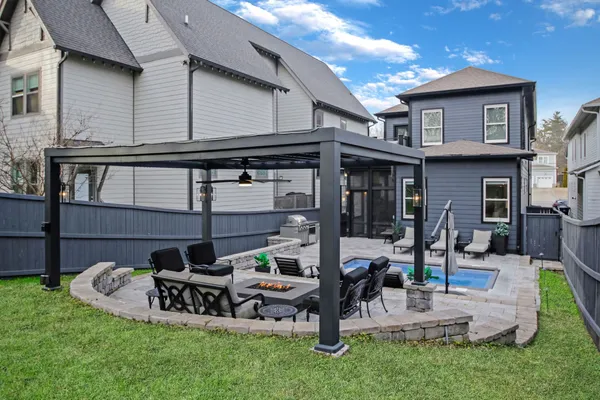 a view of a house with backyard and sitting area