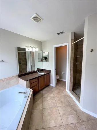 a large bathroom with a large tub and sink