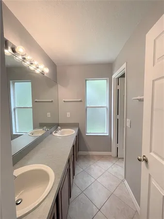 a bathroom with a sink a vanity and a mirror