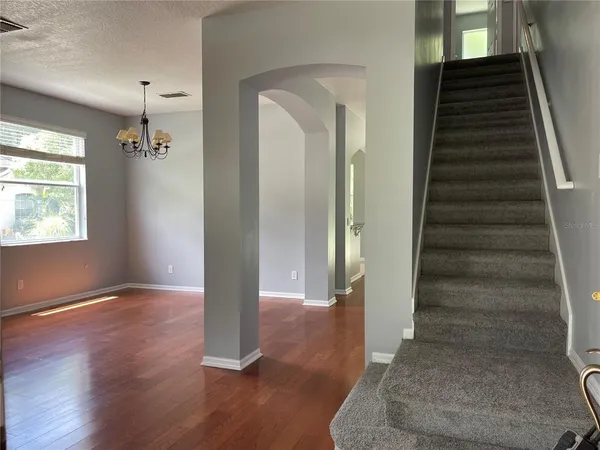 a view of an entryway with wooden floor and staircase