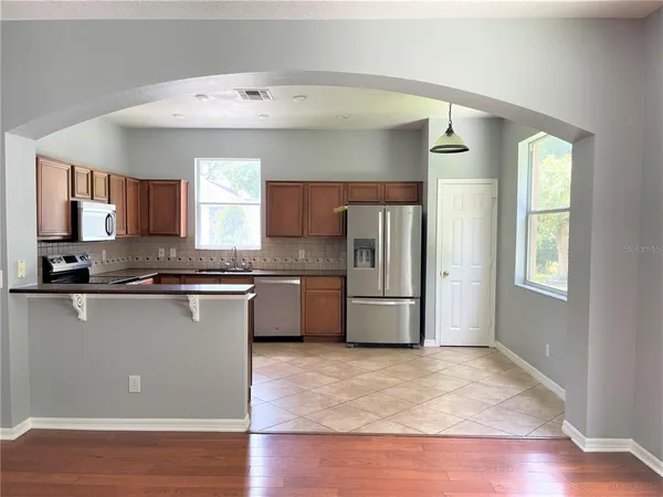 a kitchen with stainless steel appliances a refrigerator and a stove top oven