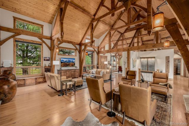 a living room with fireplace furniture and a large window