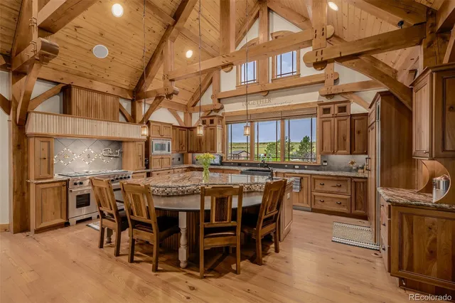 a kitchen with a large island in the center windows and furniture