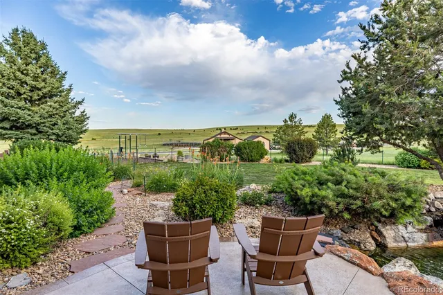 a view of a chair and table in the garden