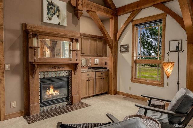 a living room with furniture a fireplace and a window