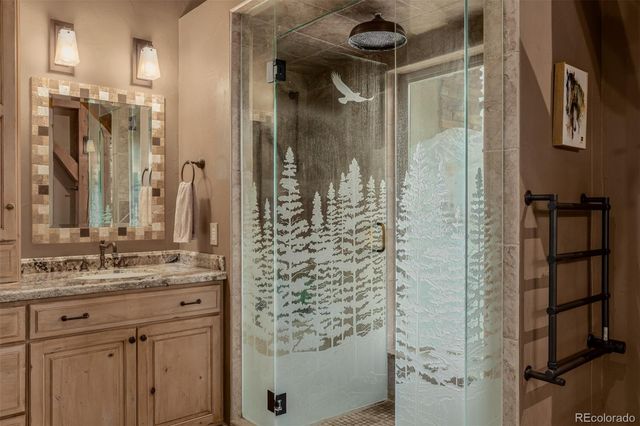 a bathroom with a shower and a sink