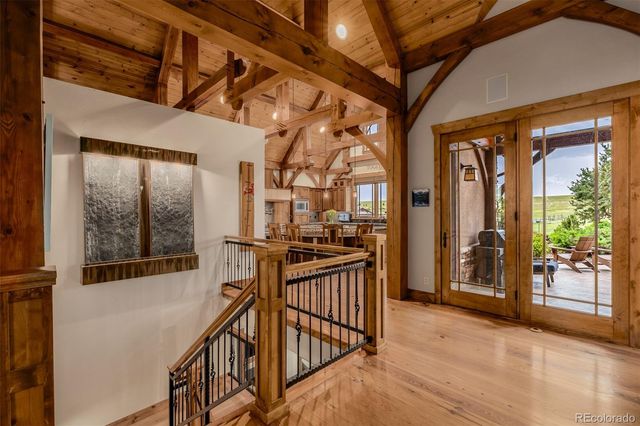 a view of a porch with wooden floor and furniture