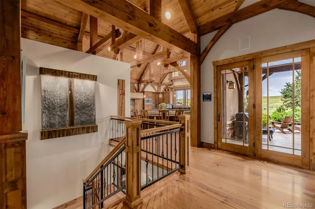 a view of a porch with wooden floor and furniture