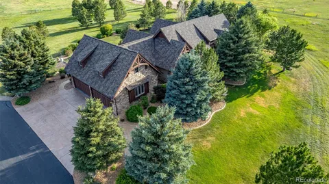 an aerial view of a house with pool outdoor seating and yard